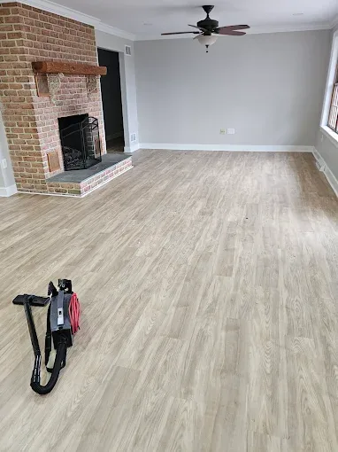 Nina's professional floor cleaning machine in a freshly cleaned living room with brick fireplace