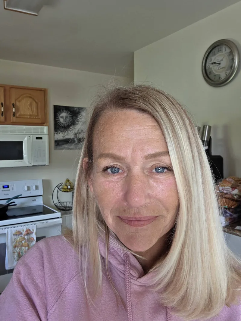 Nina smiling in her kitchen, the owner of Nina's Cleaning Service